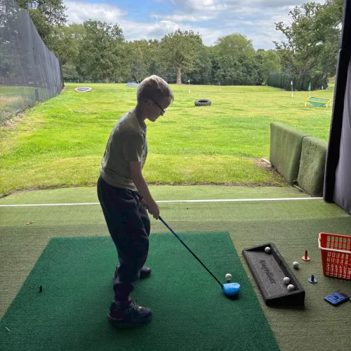 Junior golfer on the practice range